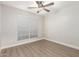 Bright bedroom with wood-look floors, ceiling fan, and window blinds at 901 N Longmore St, Chandler, AZ 85224