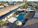 Aerial view of a home with a pool, putting green, and solar panels at 9101 W Willow Haven Ct, Sun City, AZ 85351