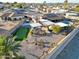 Aerial view of the home showcasing a large backyard with putting green and pool at 9101 W Willow Haven Ct, Sun City, AZ 85351