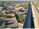 Aerial view of property showing home, putting green, and canal view at 9101 W Willow Haven Ct, Sun City, AZ 85351