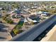 Aerial view showing a home with a pool and putting green, set against a canal at 9101 W Willow Haven Ct, Sun City, AZ 85351