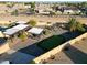 Aerial view showing backyard oasis with putting green, pergola, and solar panels at 9101 W Willow Haven Ct, Sun City, AZ 85351