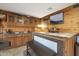 Game room bar with wood cabinets and granite countertop at 9101 W Willow Haven Ct, Sun City, AZ 85351