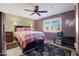 Cozy bedroom with a queen-size bed and ceiling fan at 9101 W Willow Haven Ct, Sun City, AZ 85351