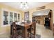 Bright dining area with wood table, chairs, and view to kitchen at 9101 W Willow Haven Ct, Sun City, AZ 85351