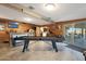 Game room with pool table, jukebox, and wood-paneled walls at 9101 W Willow Haven Ct, Sun City, AZ 85351