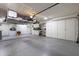 Garage with overhead storage and workbench at 9101 W Willow Haven Ct, Sun City, AZ 85351