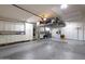 Garage with overhead storage and cabinets at 9101 W Willow Haven Ct, Sun City, AZ 85351