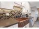 Kitchen with copper farmhouse sink and stylish backsplash at 9101 W Willow Haven Ct, Sun City, AZ 85351