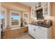 Charming kitchen nook with built-in window seat and cabinets at 9101 W Willow Haven Ct, Sun City, AZ 85351