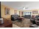 Relaxing living room with leather sofas and a large area rug at 9101 W Willow Haven Ct, Sun City, AZ 85351