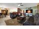 Comfortable living room featuring leather furniture and a kitchen view at 9101 W Willow Haven Ct, Sun City, AZ 85351