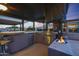 Outdoor kitchen with grill, mini-fridge and fire pit at 9101 W Willow Haven Ct, Sun City, AZ 85351