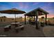 Covered patio with dining table and fire pit at 9101 W Willow Haven Ct, Sun City, AZ 85351