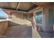 Covered patio with brick flooring and potted plants at 9101 W Willow Haven Ct, Sun City, AZ 85351