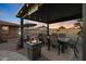 Relaxing covered patio with fire pit and seating at 9101 W Willow Haven Ct, Sun City, AZ 85351