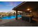 Sunset view of inviting pool and hot tub at 9101 W Willow Haven Ct, Sun City, AZ 85351