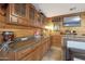 Wet bar with granite countertop and wood cabinetry at 9101 W Willow Haven Ct, Sun City, AZ 85351