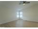 Spacious bedroom with ceiling fan and light flooring at 9144 E Balsam Ave, Mesa, AZ 85208