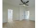 Spacious bedroom with ceiling fan and access to bathroom at 9144 E Balsam Ave, Mesa, AZ 85208