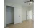 Bedroom with sliding door closet and wood-look floors at 9144 E Balsam Ave, Mesa, AZ 85208