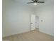 Light and airy bedroom with ceiling fan and door to hallway at 9144 E Balsam Ave, Mesa, AZ 85208