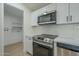 Modern kitchen with stainless steel appliances and white cabinetry at 9144 E Balsam Ave, Mesa, AZ 85208