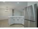 Modern kitchen with stainless steel appliances and white cabinetry at 9144 E Balsam Ave, Mesa, AZ 85208