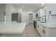 Modern kitchen with white shaker cabinets, stainless steel appliances, and quartz countertops at 9144 E Balsam Ave, Mesa, AZ 85208