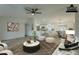 Open living room showcasing a comfortable seating area and views into the kitchen at 9144 E Balsam Ave, Mesa, AZ 85208