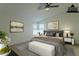 Virtually staged main bedroom with large bed and ceiling fan at 9144 E Balsam Ave, Mesa, AZ 85208