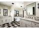 Elegant bathroom with freestanding tub, checkered floor, and dual vanities at 9820 E Thompson Peak Pkwy # 646, Scottsdale, AZ 85255