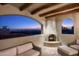 Evening view of patio with fire pit and city lights at 9820 E Thompson Peak Pkwy # 646, Scottsdale, AZ 85255