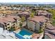 An aerial view showing the community pool, sun loungers, and surrounding buildings at 10136 E Southern Ave # 1045, Mesa, AZ 85209