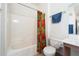 Bright bathroom featuring a shower/tub combo with a vibrant curtain and white tile walls at 10136 E Southern Ave # 1045, Mesa, AZ 85209