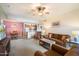 Open-concept living room featuring a ceiling fan, brown sofa, and combined dining and kitchen area at 10136 E Southern Ave # 1045, Mesa, AZ 85209