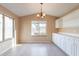 Bright dining area with white cabinets and a chandelier at 10512 E Dutchmans Trl, Gold Canyon, AZ 85118