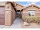 House exterior showcasing a walkway to the front door, landscaping, and a neutral color palette at 10512 E Dutchmans Trl, Gold Canyon, AZ 85118