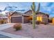 Desert landscape surrounds this one-story home with a two-car garage at 10512 E Dutchmans Trl, Gold Canyon, AZ 85118