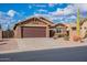 One-story house with a two-car garage and desert landscape at 10512 E Dutchmans Trl, Gold Canyon, AZ 85118