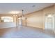 Living area with tile floors, high ceilings, and views to the kitchen and entryway at 10512 E Dutchmans Trl, Gold Canyon, AZ 85118