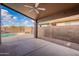 Covered patio with ceiling fan, adjacent to the pool area at 10512 E Dutchmans Trl, Gold Canyon, AZ 85118