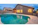 Relaxing kidney-shaped pool, reflecting the home's exterior at 10512 E Dutchmans Trl, Gold Canyon, AZ 85118