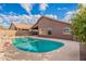 Clean pool with a stone waterfall feature and mountain views at 10512 E Dutchmans Trl, Gold Canyon, AZ 85118