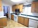 Kitchen with wood cabinets, tile floor, and a view of the dining area at 106 S 72Nd Way, Mesa, AZ 85208