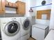 Laundry room with washer, dryer, and extra storage cabinets at 106 S 72Nd Way, Mesa, AZ 85208