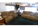 Spacious living room with two brown sofas and green carpet at 106 S 72Nd Way, Mesa, AZ 85208