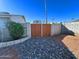 Backyard access with double wood gates and stone landscaping at 10618 N 27Th St, Phoenix, AZ 85028