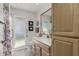 Bathroom featuring light wood cabinets, a toilet, and a shower at 11009 W Crestbrook Dr, Sun City, AZ 85351