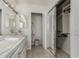 Bathroom with double sinks, a large mirrored closet and a linen closet at 11009 W Crestbrook Dr, Sun City, AZ 85351